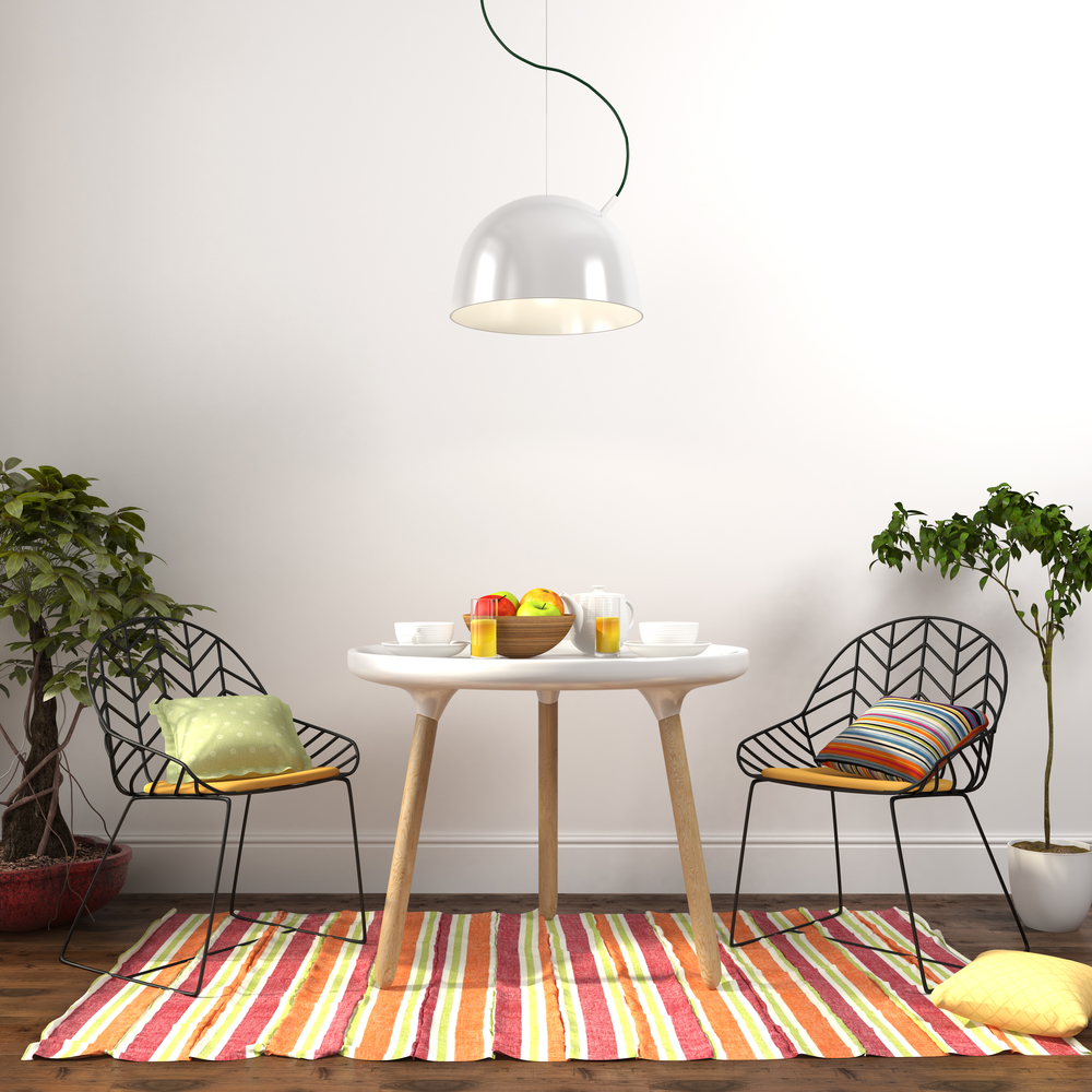 Modern dining room with colored decoration and plants on the sides