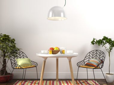 Modern dining room with colored decoration and plants on the sides